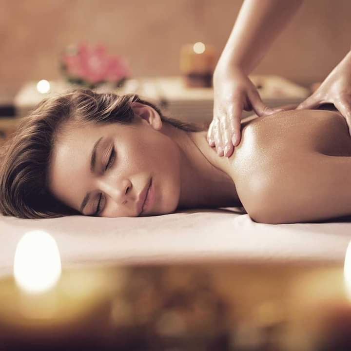 An image of a woman receiving a relaxing back massage.